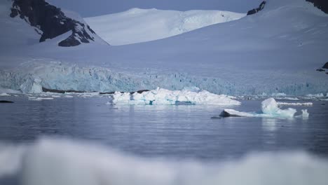 Global-Warming-in-Antarctica,-Warming-Oceans-with-Sunny-Sunshine-Sun-Shining-on-Ice-and-Glacier-with-Mountains-Landscape-Scenery,-Ocean-Sea-Water-Warming-in-Antarctic-Peninsula-Winter-Scene