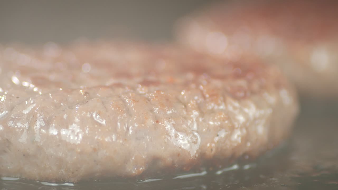 Burger the meat is fried with hot steam in a frying pan.