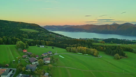 idyllic village with fresh autumn nature by the lake mountains