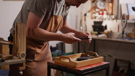 Bearded-man-takes-photo-of-stylish-leather-purse-in-studio