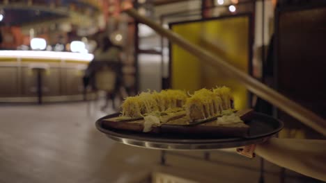 sushi tray being served in a restaurant