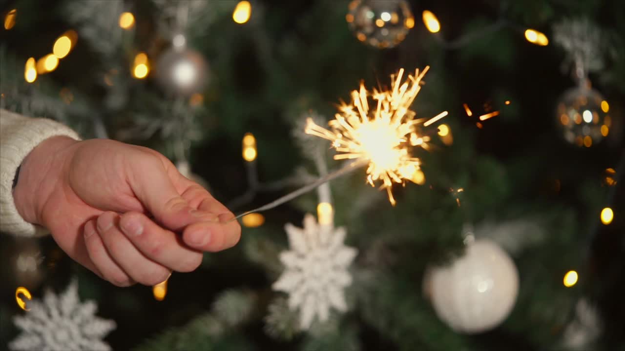 Sparkler in front of Christmas Tree