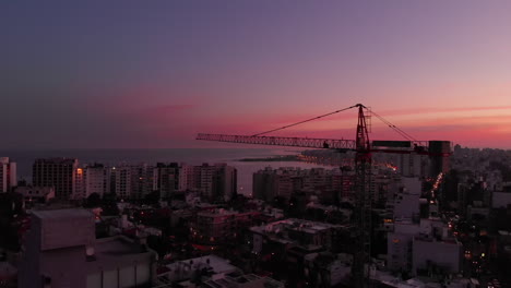 construction crane in the city at sunset ultra wide