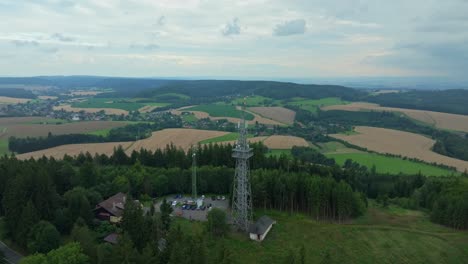 drone view of the czech landscape of fields and meadows. in the foreground, the lookout tower at the mouth of the ústí nad orlicí