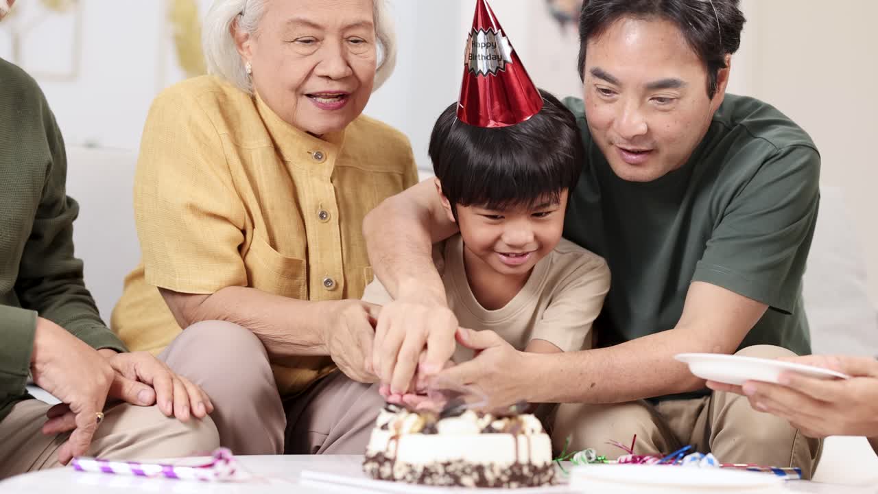 A joyful family birthday celebration with cake cutting, featuring an elderly man, a child, and a parent in a warm setting