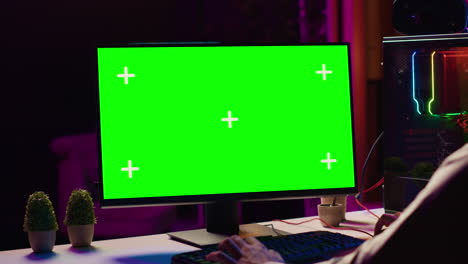 player cooperating with teammates in coop videogame using chroma key monitor, close up