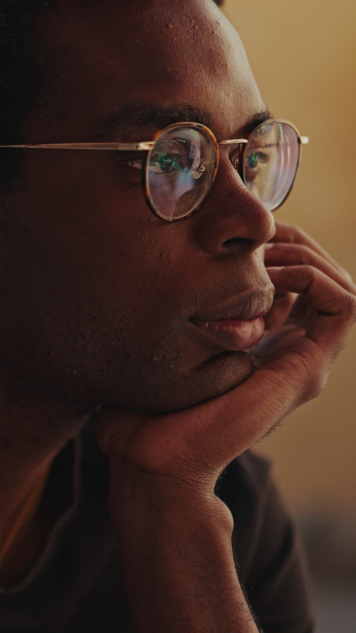 Close-up Portrait of a Thoughtful Young Black Man Wearing Glasses