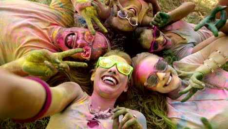 multi-ethnic group celebrating holi festival in park