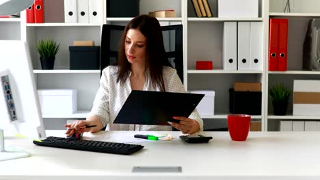 mujer de negocios trabajando en computadora en una oficina ligera