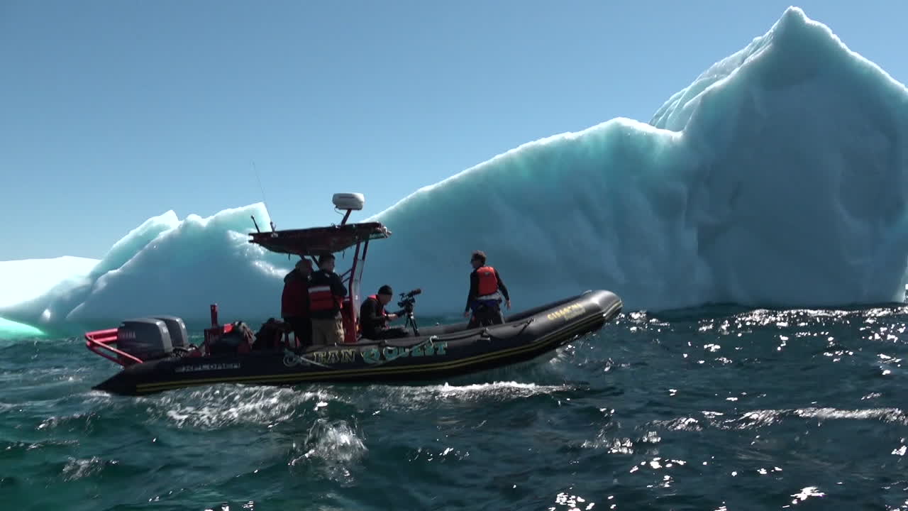 在北極的巨型冰山旁邊, 一艘星座船上的研究員