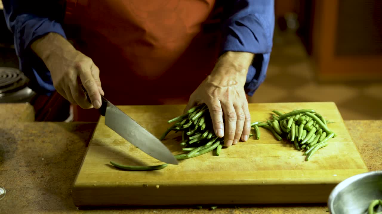 Chopping green beans on a cutting board