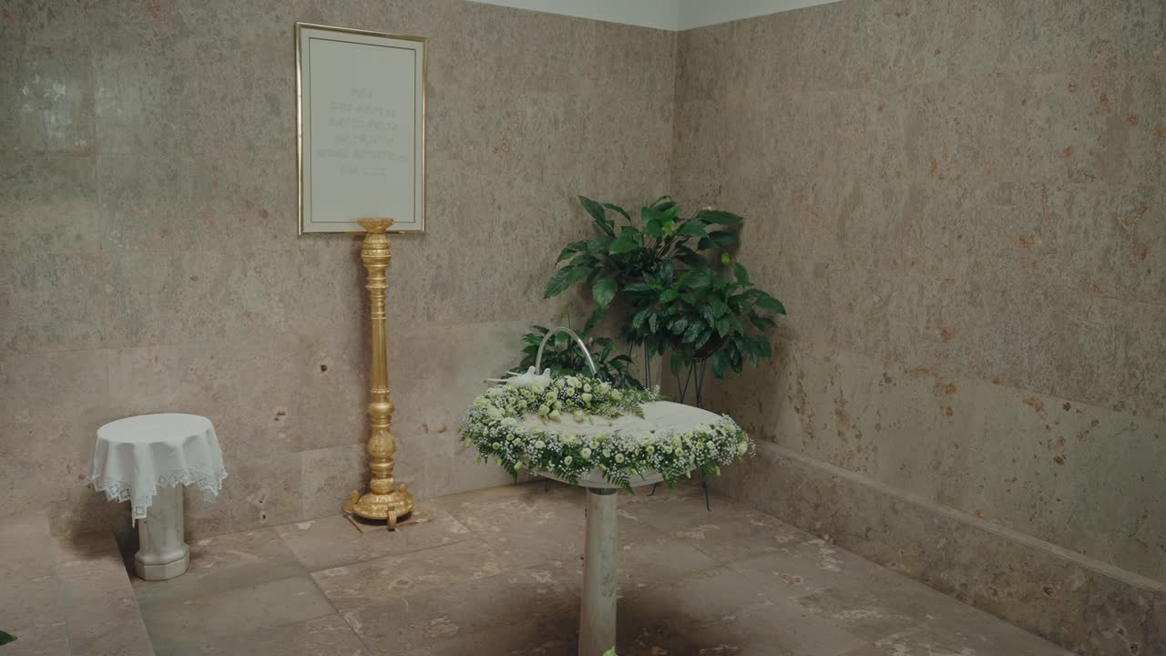 White floral decorated baptismal font inside church interior