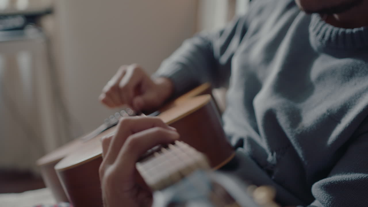 Young Musician Playing the Guitar at Home