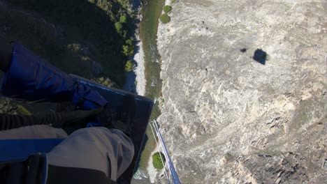 walking to the edge of the nevis bungy jump in queenstown new zealand