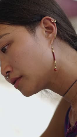 portrait of a woman with jewelry and piercings