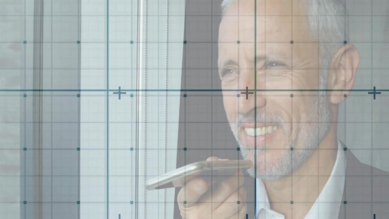 Businessman raising smartphone and delivering business update with grid overlay beside window