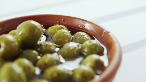 green olives and herbs in vinegar