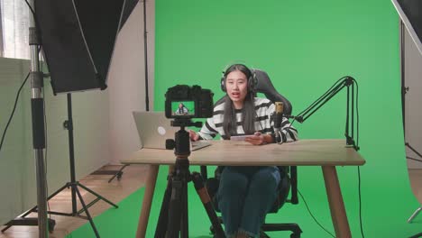 woman streaming video content using green screen