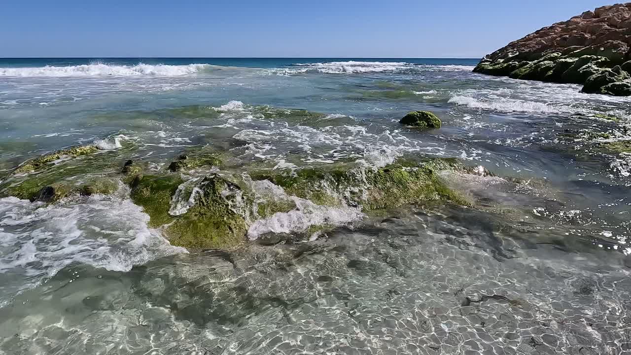 Hand held clip exploring rock pools along Clayton's Beach, Mindarie - Perth