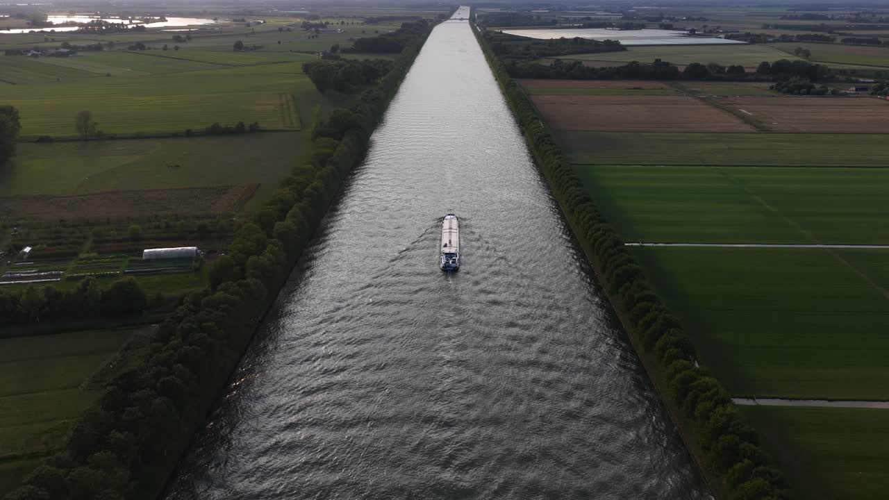 Aerial drone video featuring an industrial transport ship on the Amsterdam-Rhine Canal in the Netherlands, emphasizing water transport, infrastructure, and the Dutch landscape