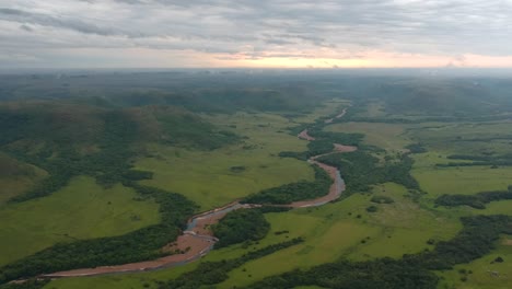 aerial view of a river flowing through the grassland of uruguay