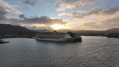 Two-Cruise-ships-at-Puerto-Plata-port-at-sunset,-aerial-drone-view