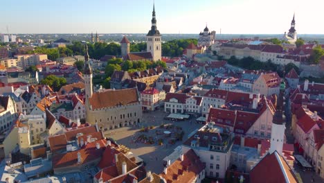 Tallinn's historic old town with red rooftops and medieval architecture at sunset, aerial view