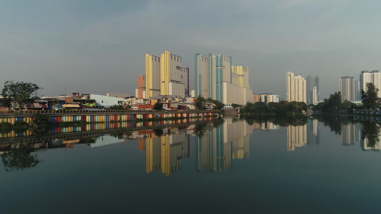 the reflection of building in the lake of sunter jakarta indonesia by drone 4K