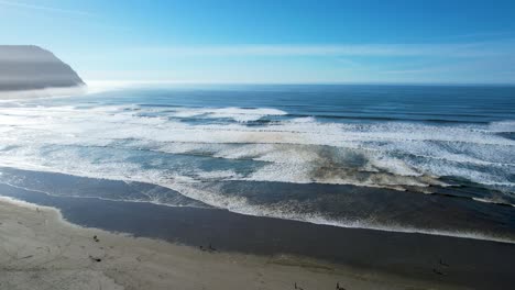 4k aerial drone shot floating over ocean horizon at seaside, oregon beach