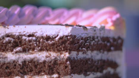 delicious chocolate birthday cake with colorful whipped cream topping with additional layers of cream and iciing frosting on top. celebration occasion.