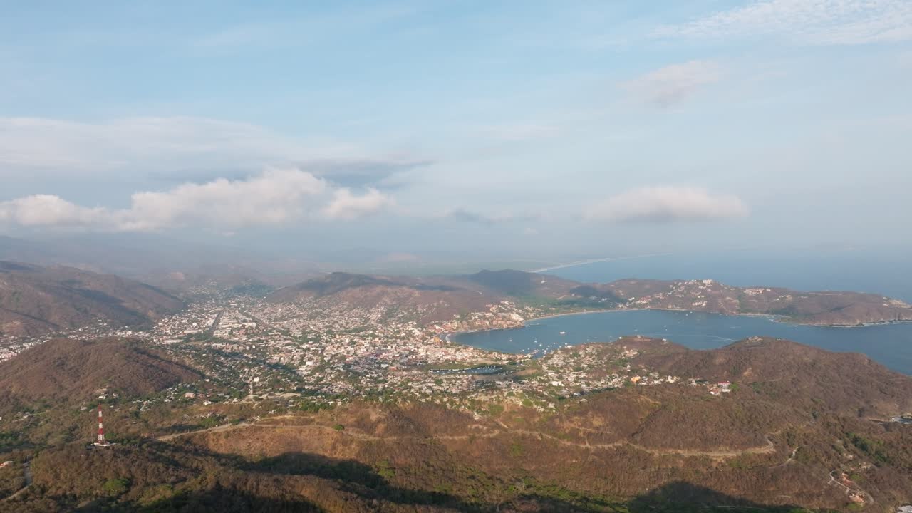 DRONE: REVEAL SHOT OF ZIHUATANEJO BEACH AT SUNSET