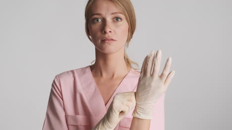 caucasian female doctor wearing medical gloves.