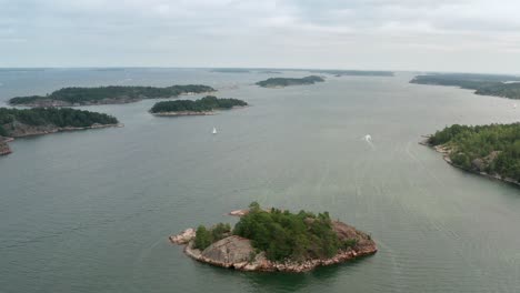 Aerial-shot-of-Stockholm-archipelago-in-Sweden-on-a-cloudy-day-with-boat-and-yacht