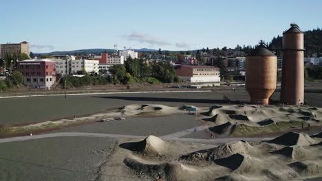 sunny pump tracks with bikers near kulshan trackside beer garden in bellingham city, washington