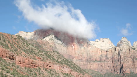 timelapse shot of cloud formations over a mountain peak in zion national park