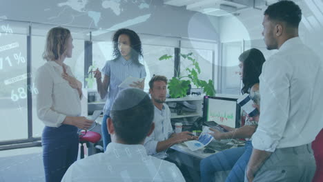 statistical data processing against group of colleagues working together at office