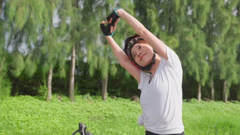 woman cycling and stretching outdoors