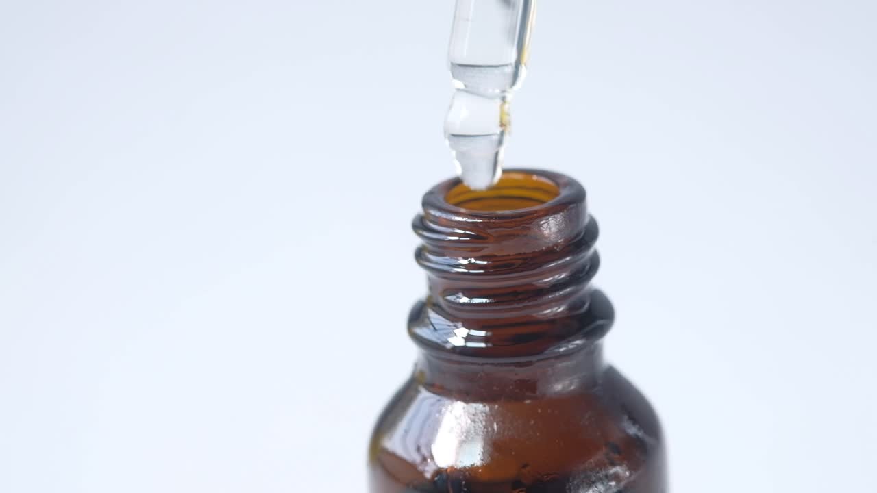 Dropper Filling a Brown Bottle