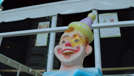 statue of a laughing clown in outdoor funfair