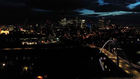 Aerial-drone-view-of-the-Edmonton-Walterdale-Bridge-over-the-North-Saskatchewan-River-during-a-summer-night-and-the-downtown-skyline-in-the-background