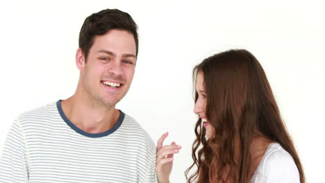 Smiling-woman-whispering-something-to-boyfriend-