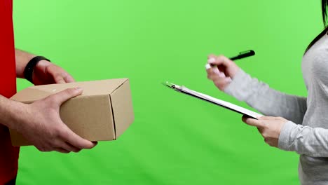 woman receiving and signing package from mailman