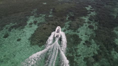 toma aérea de un barco en un mar colorido