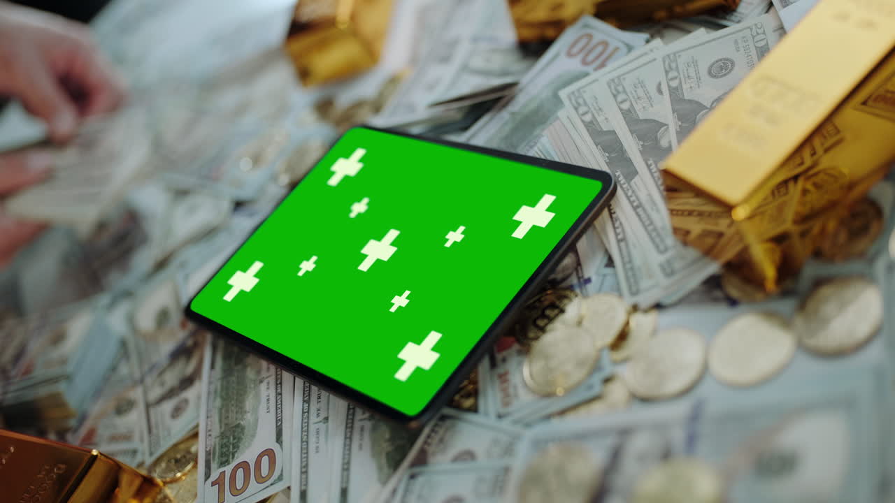 Tablet with Green Screen on Money and Gold