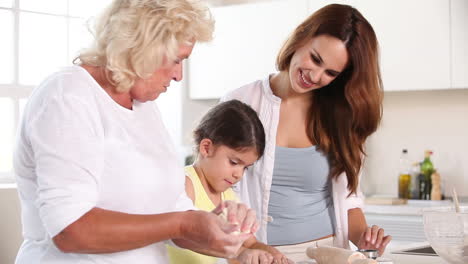 grandmother child mother preparing the dough