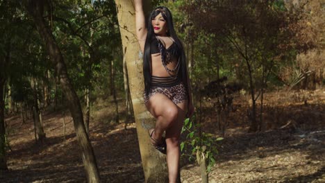 glamorous woman posing in a forest