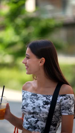 young woman enjoying a drink outdoors