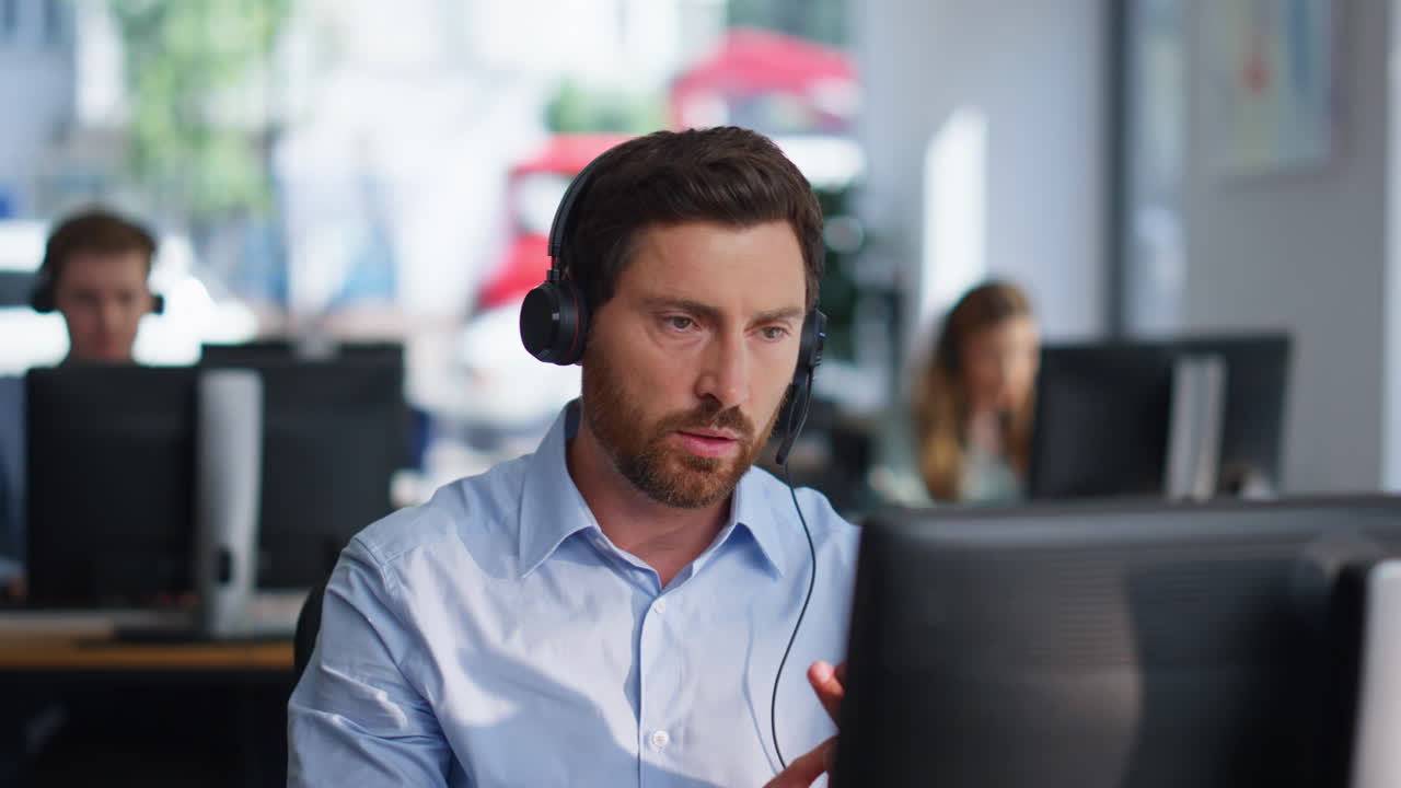 Online manager talking headphones providing customer support in office closeup