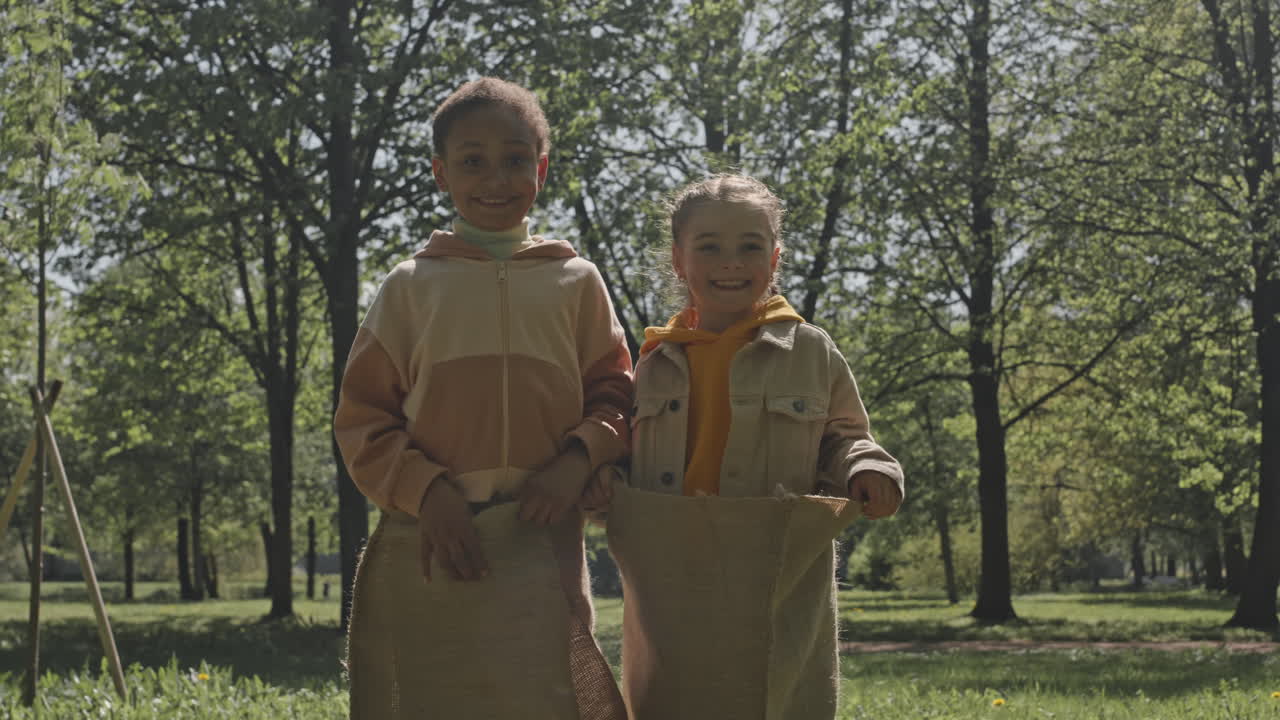 Children playing sack race in the park