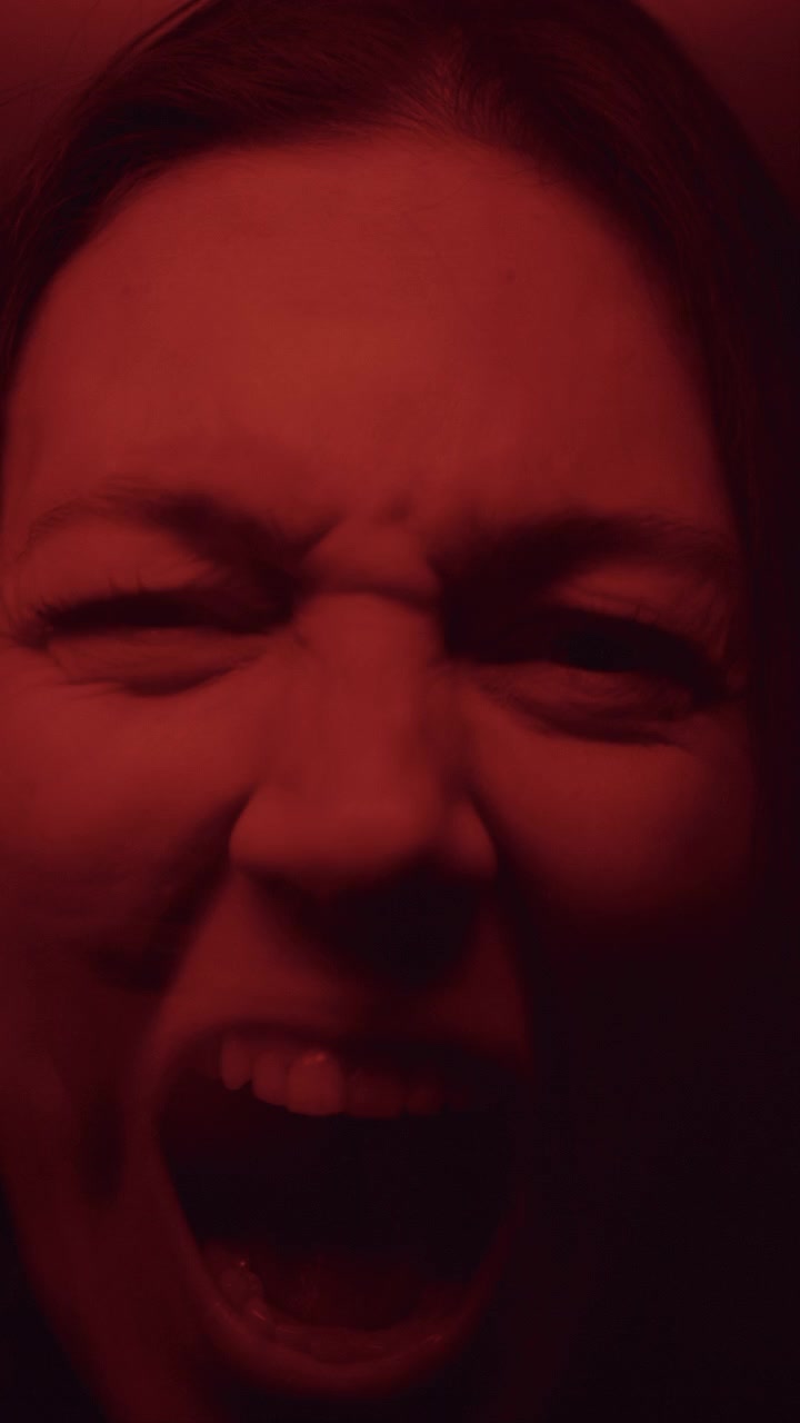 Kaleidoscopic Effect Portrait of Mad Woman Shouting in Dark Red Illumination